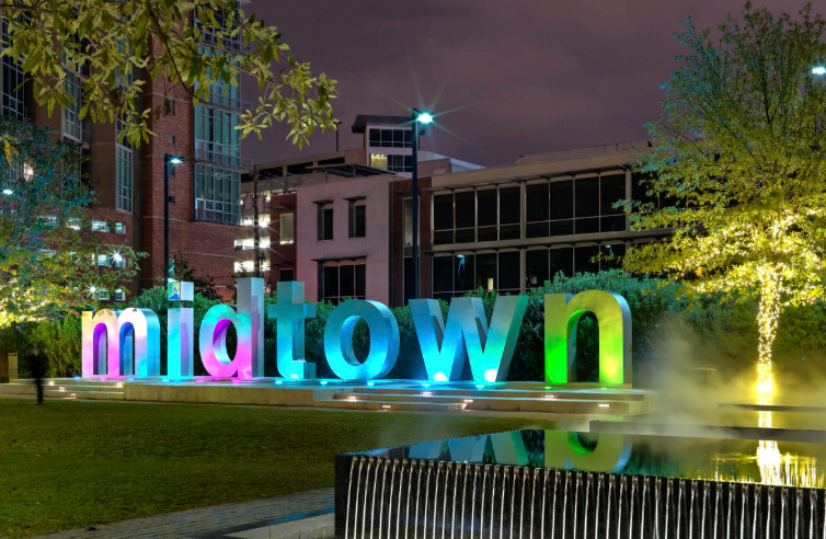Midtown Houston illuminated sign at night — child custody attorney Houston TX serving Midtown W-2 professional custody cases